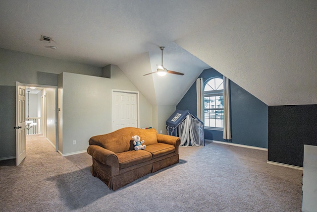 interior space with visible vents, carpet, a ceiling fan, baseboards, and vaulted ceiling