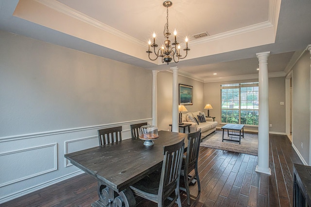 dining room featuring dark wood-style flooring, ornate columns, visible vents, and a raised ceiling