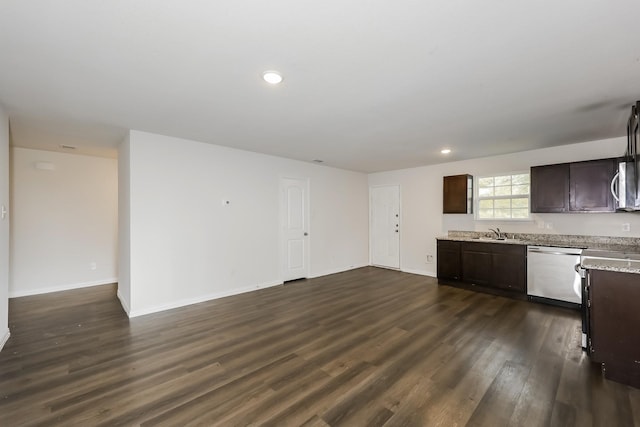 kitchen with dark brown cabinets, a sink, dishwasher, baseboards, and dark wood-style floors