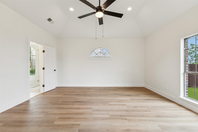 empty room featuring a healthy amount of sunlight, light wood-style floors, a ceiling fan, and visible vents