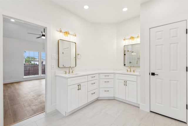 bathroom featuring double vanity, a ceiling fan, walk in shower, a sink, and recessed lighting