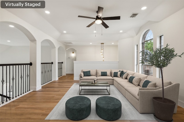 living area featuring ceiling fan, visible vents, wood finished floors, baseboards, and recessed lighting