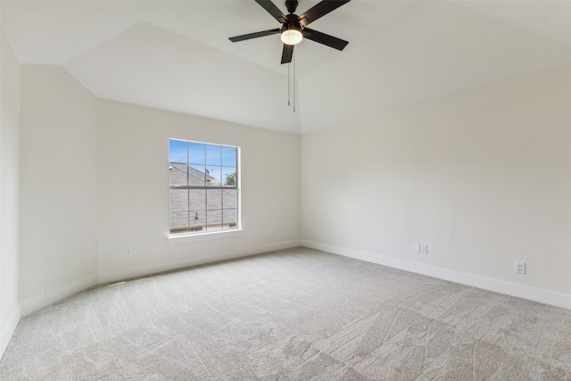 unfurnished room with carpet flooring, a ceiling fan, baseboards, and vaulted ceiling