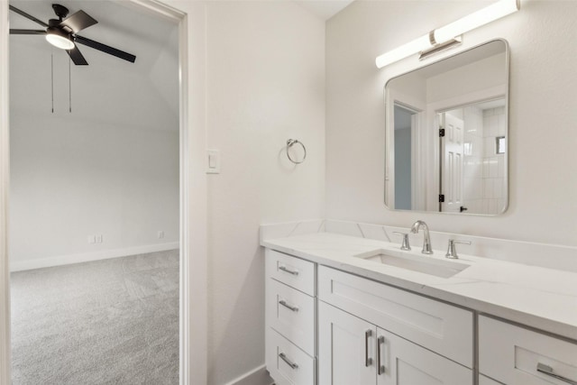 bathroom featuring vanity, baseboards, and a ceiling fan