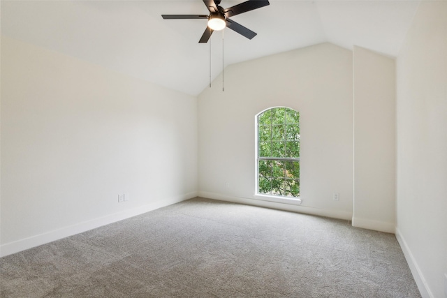 unfurnished room with carpet floors, a ceiling fan, baseboards, and vaulted ceiling