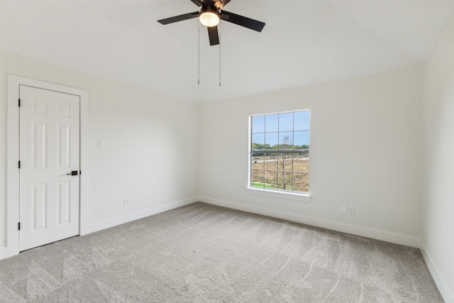 spare room with ceiling fan, baseboards, and carpet