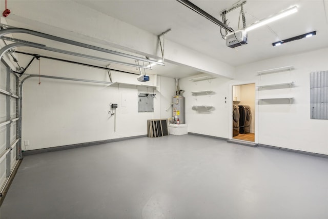 garage with baseboards, washing machine and dryer, a garage door opener, and gas water heater