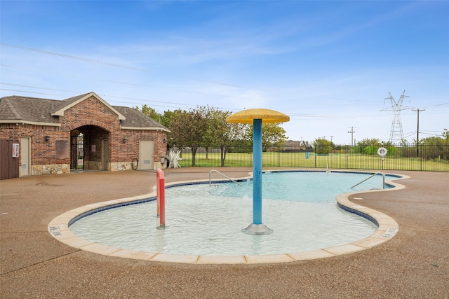 community pool featuring a patio and fence
