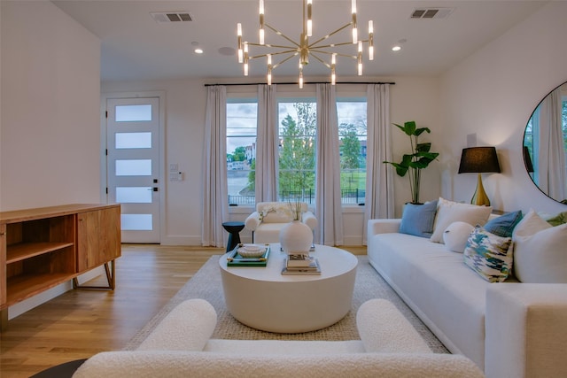 living room featuring a chandelier, visible vents, recessed lighting, and light wood-type flooring