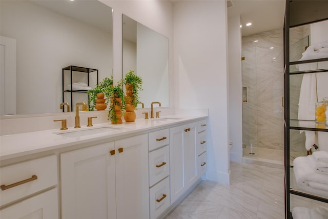 bathroom with double vanity, a sink, marble finish floor, and a marble finish shower
