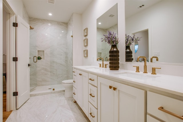 full bath with double vanity, a sink, a marble finish shower, and toilet