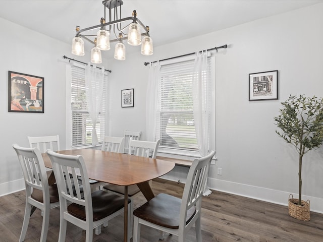 711 W Knox St, Ennis, TX 75119 - dining room featuring plenty of natural light, dark wood-type flooring, and a chandelier
