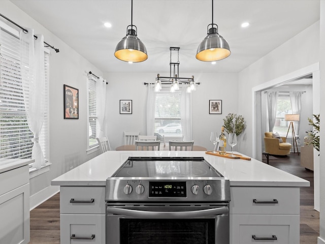 kitchen with recessed lighting, light countertops, dark wood-style floors, and stainless steel range with electric cooktop