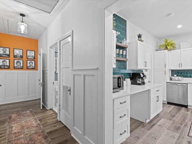 hallway with light wood-type flooring, recessed lighting, wainscoting, and visible vents