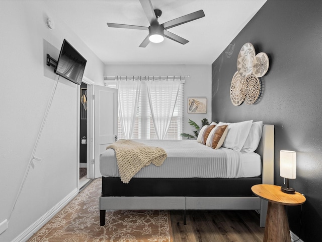 bedroom with baseboards, ceiling fan, and wood finished floors