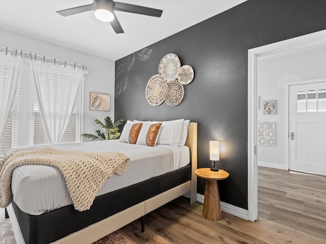 711 W Knox St, Ennis, TX 75119 - bedroom with wood finished floors and ceiling fan