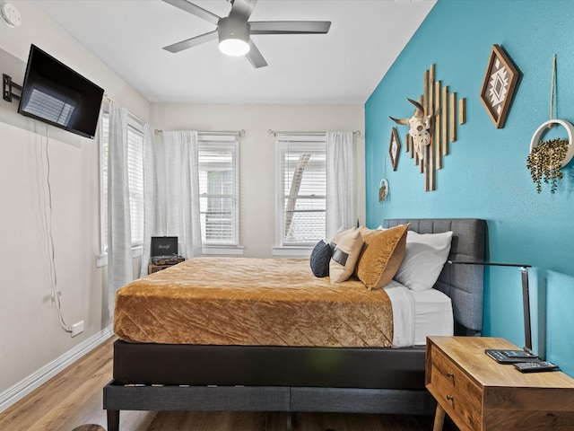 bedroom featuring baseboards, ceiling fan, and wood finished floors