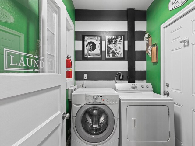 clothes washing area with laundry area and washer and dryer