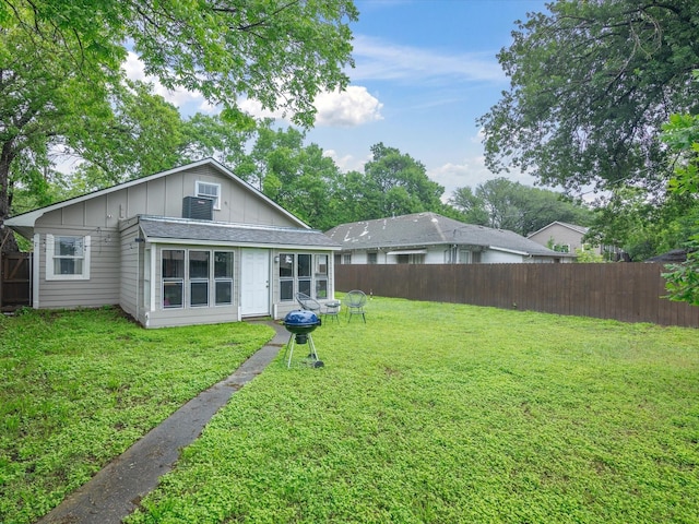 711 W Knox St, Ennis, TX 75119 - back of property featuring board and batten siding and a fenced backyard
