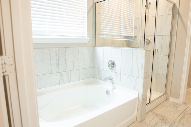 1714 Cecil Crest Ln, Forney, TX 75126 - bathroom with baseboards, a bath, marble finish floor, and a stall shower