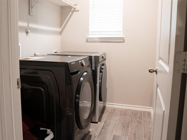 1714 Cecil Crest Ln, Forney, TX 75126 - laundry room featuring laundry area, washer and clothes dryer, baseboards, and wood tiled floor