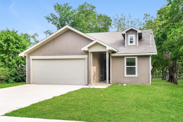 view of front of home with driveway, a shingled roof, a front yard, and a garage