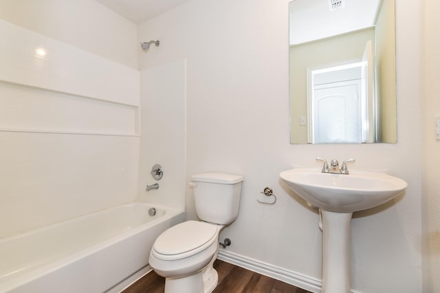 bathroom featuring shower / tub combination, a sink, toilet, baseboards, and wood finished floors
