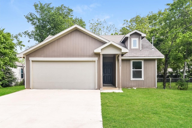view of front facade featuring roof with shingles, a front yard, fence, concrete driveway, and an attached garage