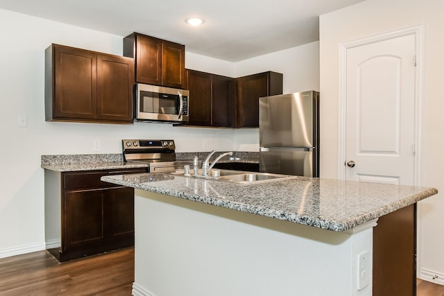 kitchen featuring a sink, dark wood finished floors, dark brown cabinets, and stainless steel appliances