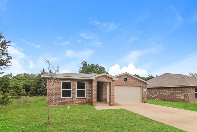 ranch-style house with an attached garage, a front yard, brick siding, and concrete driveway