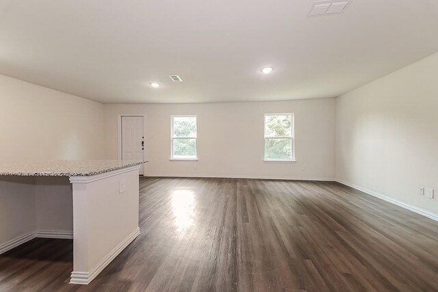 unfurnished room featuring visible vents, recessed lighting, dark wood-style flooring, and baseboards