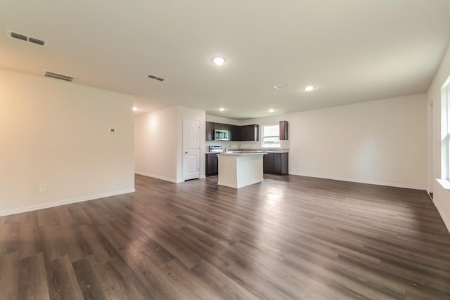 unfurnished living room with baseboards, recessed lighting, and visible vents