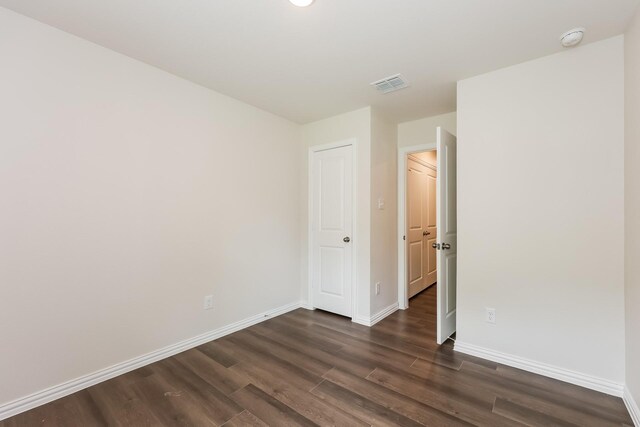 609 Sherman St, Waco, TX 76704 - empty room featuring baseboards, visible vents, and dark wood-type flooring