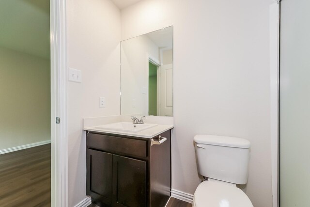 609 Sherman St, Waco, TX 76704 - bathroom with vanity, toilet, and wood finished floors