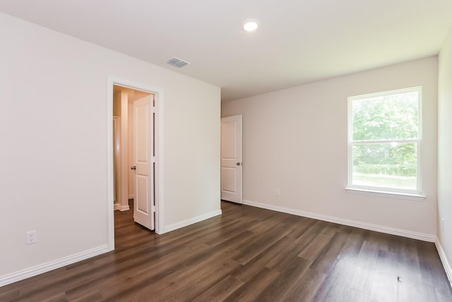 609 Sherman St, Waco, TX 76704 - spare room featuring visible vents, recessed lighting, dark wood-style flooring, and baseboards