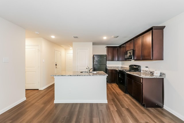 609 Sherman St, Waco, TX 76704 - kitchen featuring a sink, black appliances, dark wood-style flooring, and visible vents