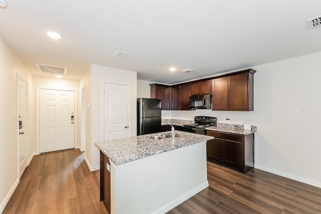 609 Sherman St, Waco, TX 76704 - kitchen featuring visible vents, a sink, black appliances, and dark wood-type flooring