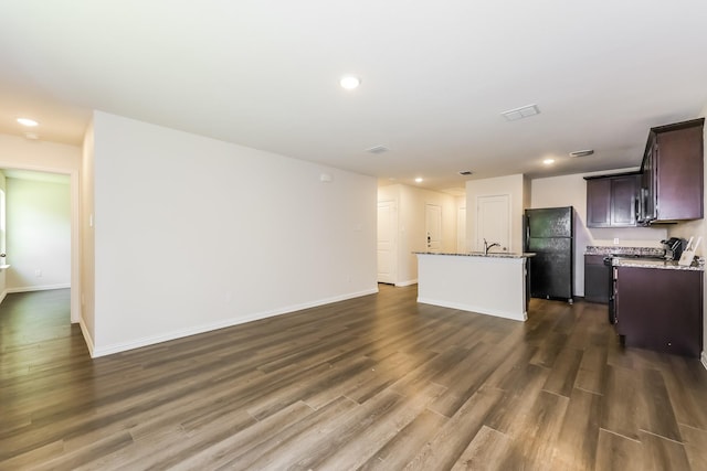 609 Sherman St, Waco, TX 76704 - unfurnished living room with recessed lighting, baseboards, dark wood finished floors, and a sink