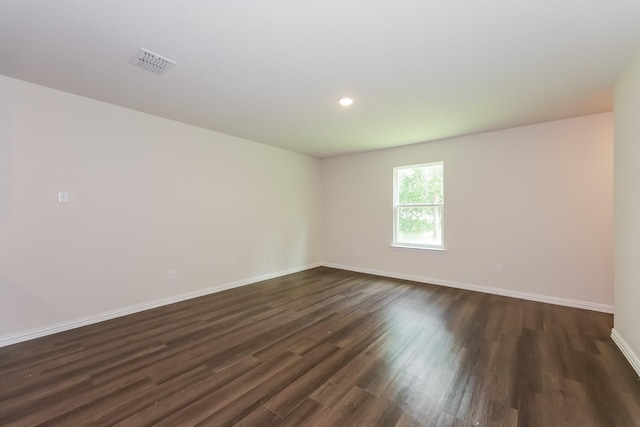 609 Sherman St, Waco, TX 76704 - spare room featuring baseboards, dark wood-type flooring, recessed lighting, and visible vents