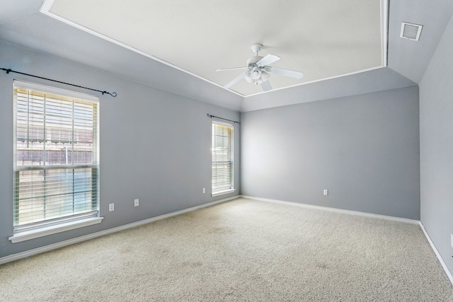empty room with visible vents, a ceiling fan, carpet, and a healthy amount of sunlight