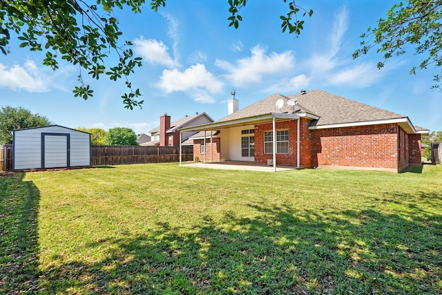 back of property with a patio, a fenced backyard, a yard, and a storage shed