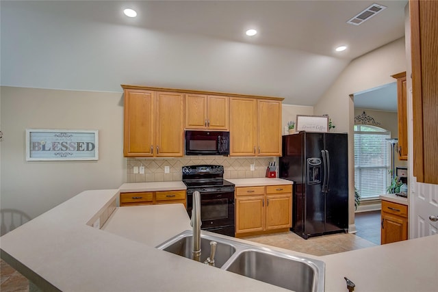 kitchen featuring light countertops, decorative backsplash, lofted ceiling, visible vents, and black appliances