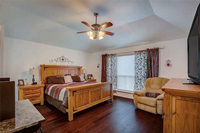 bedroom with a ceiling fan, vaulted ceiling, and dark wood-type flooring