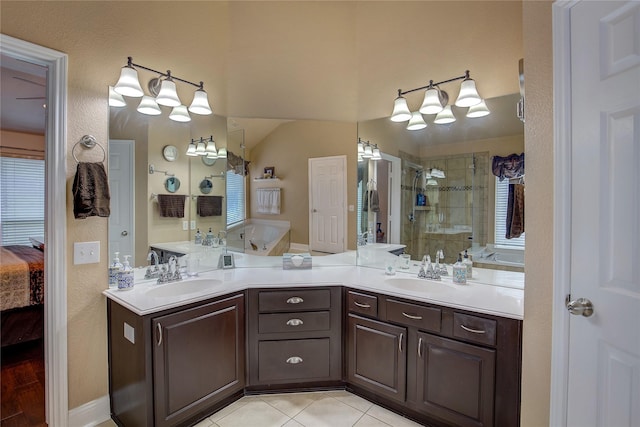 ensuite bathroom featuring double vanity, a sink, connected bathroom, and a shower stall