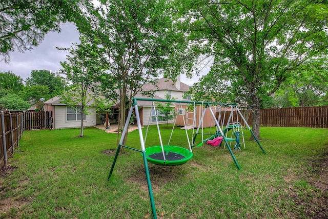 view of playground with a fenced backyard and a yard