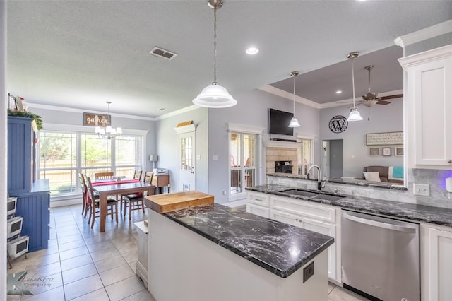 kitchen with a kitchen island, visible vents, dishwasher, a sink, and white cabinetry