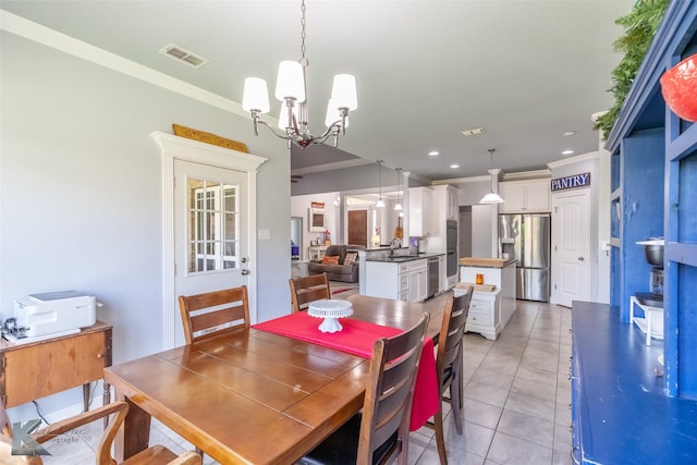 dining room featuring visible vents, ornamental molding, light tile patterned floors, and an inviting chandelier