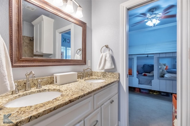 bathroom featuring a sink, double vanity, and visible vents