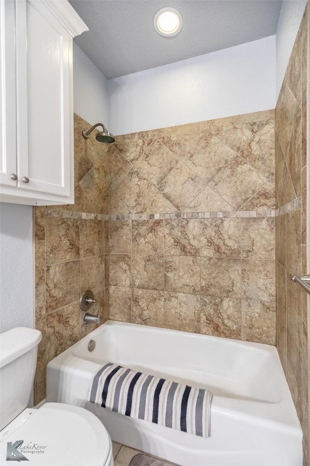 bathroom with toilet and shower / washtub combination
