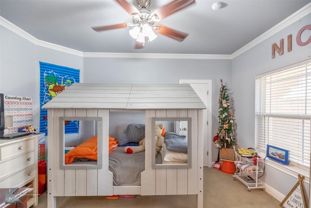 bedroom with crown molding, baseboards, ceiling fan, and carpet